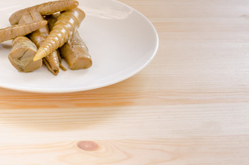Bamboo shoots in white dish on wooden table background