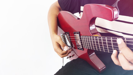 Fototapeta premium A man playing red electric guitar