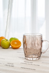 empty glass with fruit near window on the table