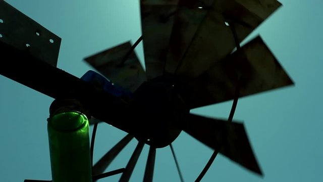 Route 66 Glass Bottle and Windmill / Route 66 Glass Bottle Farm with a green bottle catching the sunlight between blades of a spinning Windmill