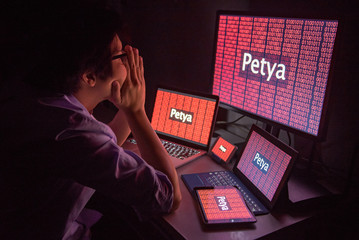 Young Asian male frustrated, confused and headache by Petya or Petrwrap ransomware attack on...