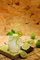 Kaffir lime So, Bergamot soda Cool drink, Thailand tradition Herb for Treatment of Acid Reflux, with Oriental Earth tone map background.Have some space for write wording