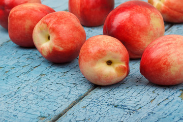Ripe red peaches on the blue wooden table