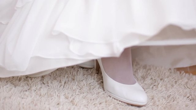 Feet of the bride in shoes. Feet of the bride in white shoes