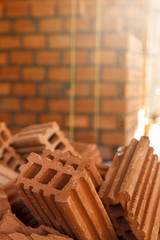Close up of pile of red clay bricks in construction site