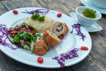 Baked chicken rolls with vegetable salad and mashed potato