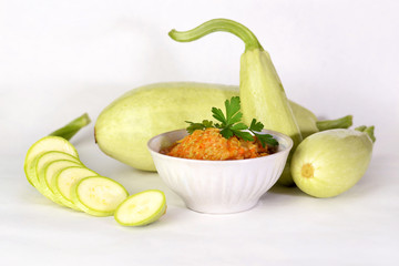 Caviar from squash in a bowl and fresh zucchini.