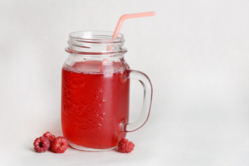 Raspberry drink in a glass jar.