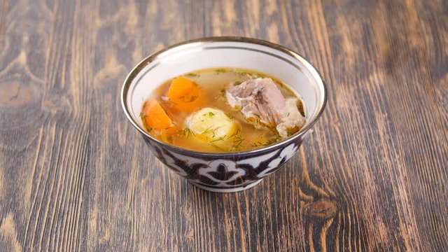uzbek soup on wooden table