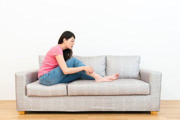 pretty elegant female student sitting on sofa