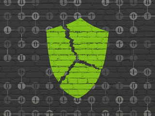 Protection concept: Broken Shield on wall background