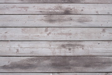 Naklejka premium The surface of the old darkened wood. The boards of the bridge over the lake.