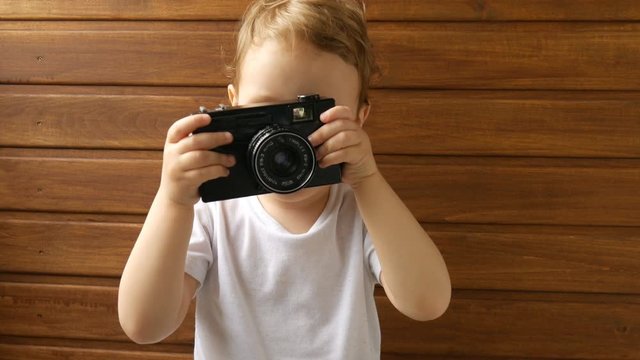 Baby plays with vintage camera