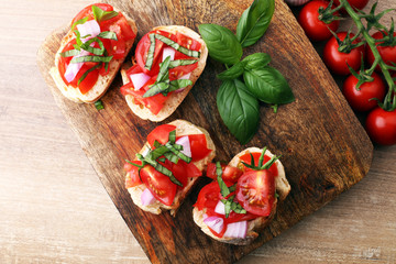 Bruschetta with tomatoes, herbs and oil on toasted garlic cheese bread toasted with chopped tomatoe