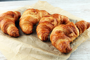 freshly baked croissants on white board, bakery concept