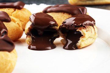 Traditional French dessert. Eclair with chocolate icing. Pastery concept