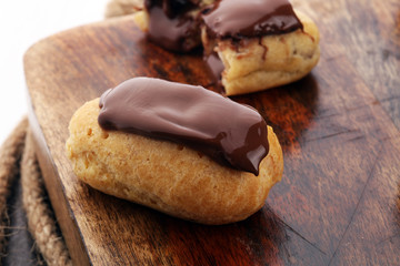 Traditional French dessert. Eclair with chocolate icing. Pastery concept