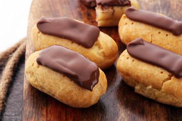 Traditional French dessert. Eclair with chocolate icing. Pastery concept