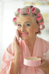 senior woman applying make up
