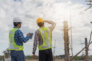 Two young man architect on a building construction site