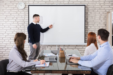 Businessman Giving Presentation In Meeting
