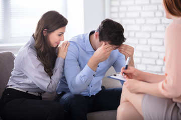 Woman Consoling His Husband Sitting With Psychologist