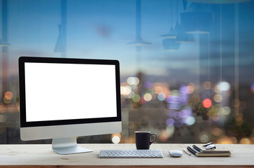 desktop computer on work table and city night background - obrazy, fototapety, plakaty