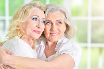 mature woman hugging mother 