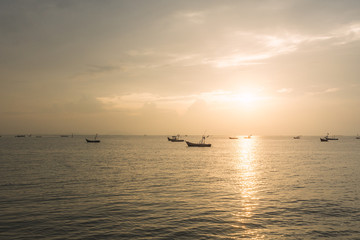 Naklejka na ściany i meble boats with a beautiful sunset at the sea