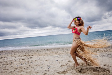 Happy hawaiian woman portrait dancing on the beach © patronestaff