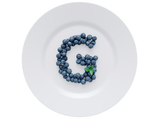 Blueberry font isolated on white ceramic dish. Letter G
