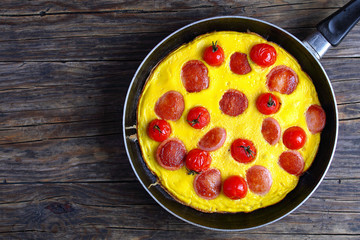 omelette with sausages and cherry tomatoes