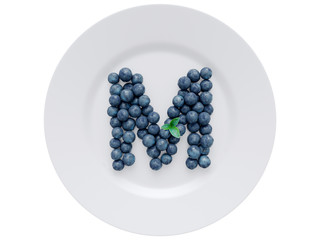 Blueberry font isolated on white ceramic dish. Letter M