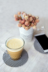 Ice coffee, phone and headphones on white wooden table. Top view vintage style.