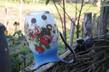 Porcelain jar on a wooden fence © Stephan