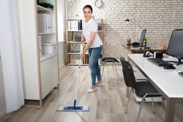 Young Woman Cleaning The Floor
