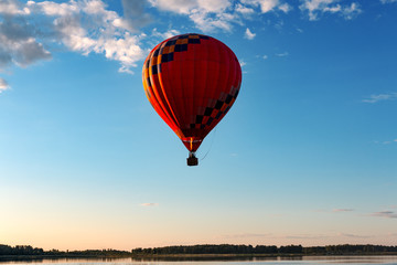 A balloon flies over the lake