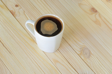 Black Coffee in White Ceramic Cup on Wooden Table