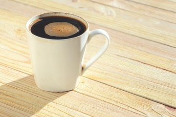 Black Coffee in White Ceramic Cup on Wooden Table