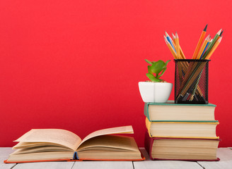 education and wisdom concept - open book on wooden table, color background