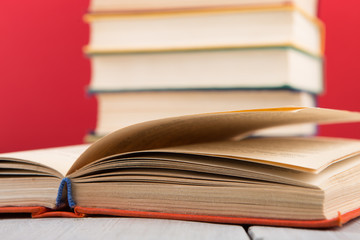 Fototapeta premium education and wisdom concept - open book on wooden table, color background