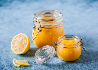 Lemon Curd in Jars over Blue Background