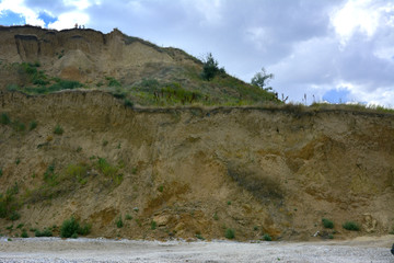 Steep precipice of the coastline. Emergency condition of the slope.