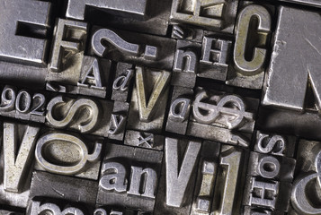 Metal Letterpress Types. A background from many historic typographical letters in black and white with white background.
