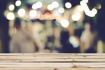 Wooden table on font blurred people on street background