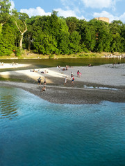 People relaxing by the Isar river in Munich (Bavaria, Germany)
