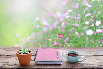 Red tea and plant with notebook at outdoor