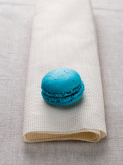 Delicious macaroon vanilla flavor presented on a well folded fabric.