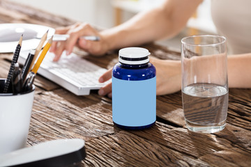 Glass Of Water With Pills Bottle