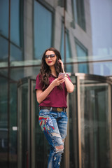Girl with sunglasses using mobile phone © nagaets